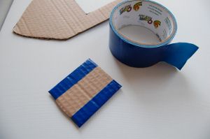 To make your toy boat water tight, cover the pieces with duct tape