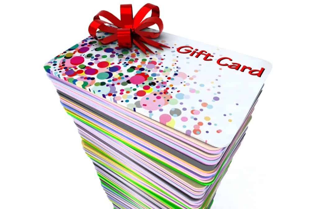 Stack of colored gift cards with red bow.