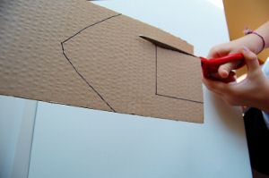 Cut along the lines you drew for your rubber band powered boat