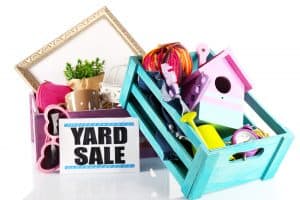 yard sale sign with box of items