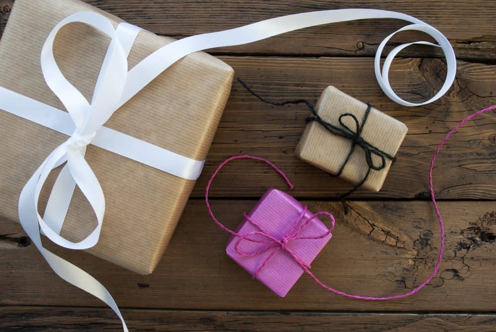 A large box and two small boxes wrapped in brown papers with ribbons.