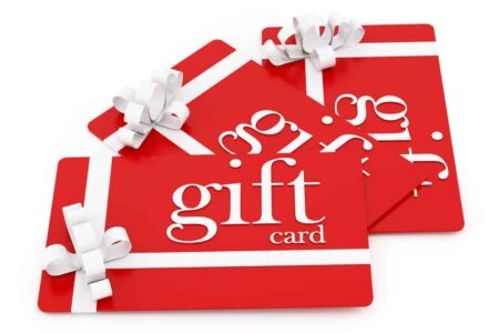 Red gift cards with white ribbons, with texting saying "gift card"