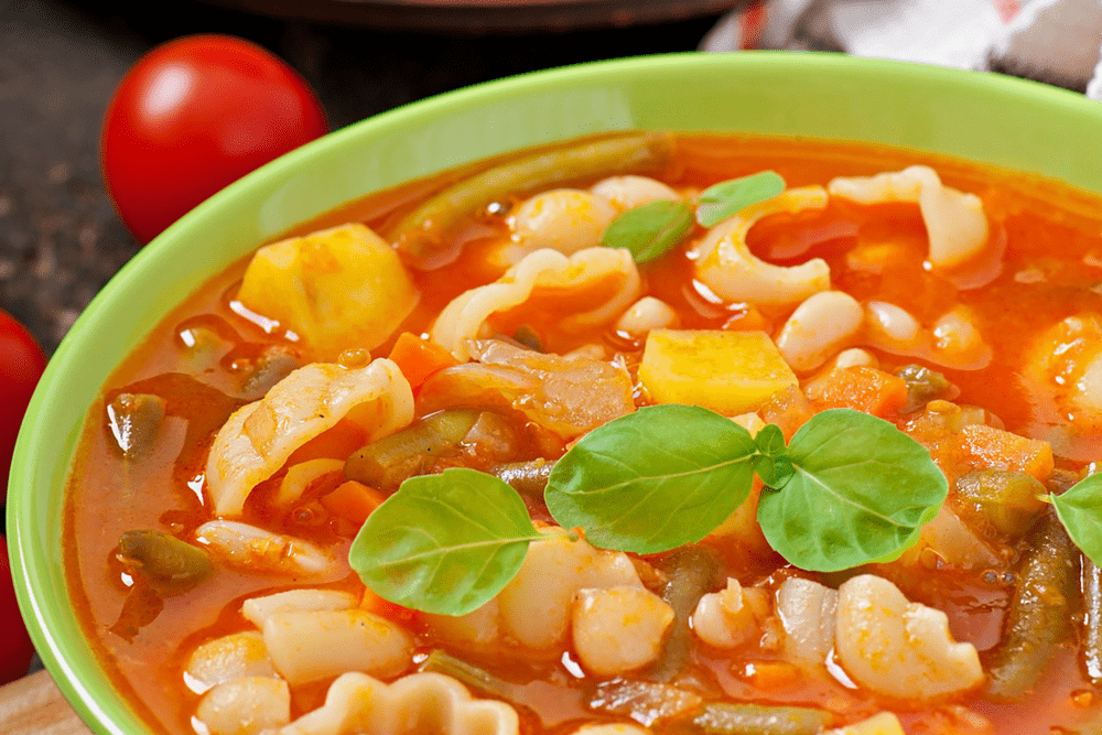 A bowl of vegetable soup with pasta
