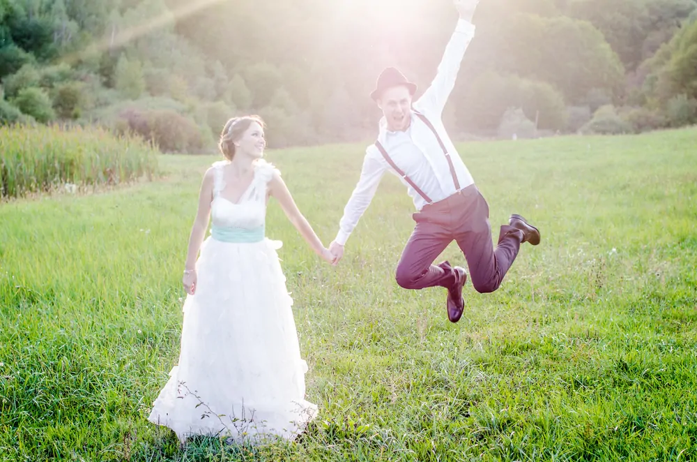 Bride and groom in a meadow.