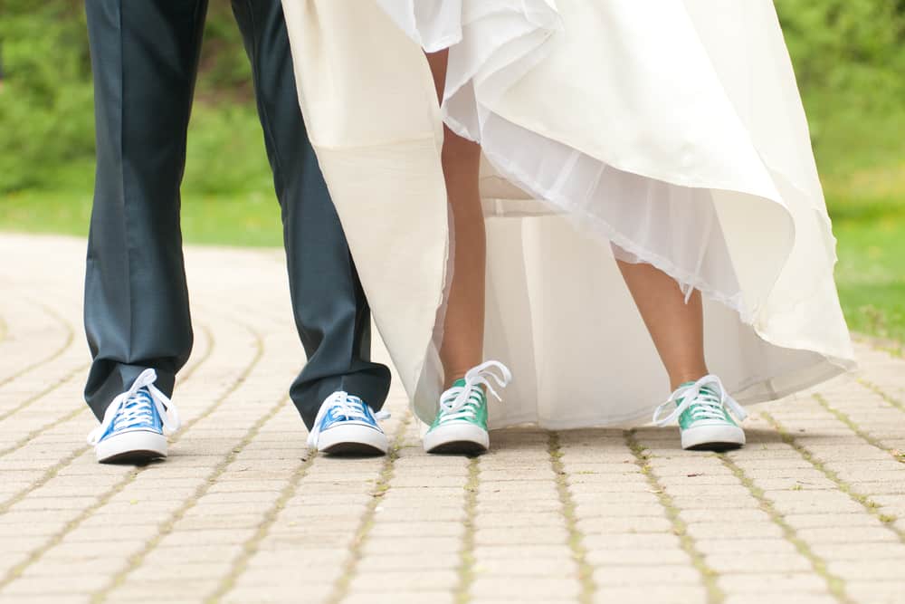 Closeup of sneaker-wearing bride and groom.