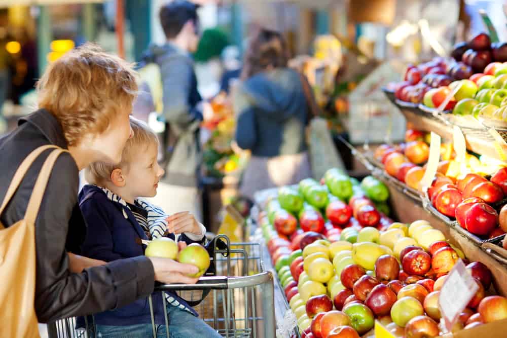 Mother and child shopping for fruit.
