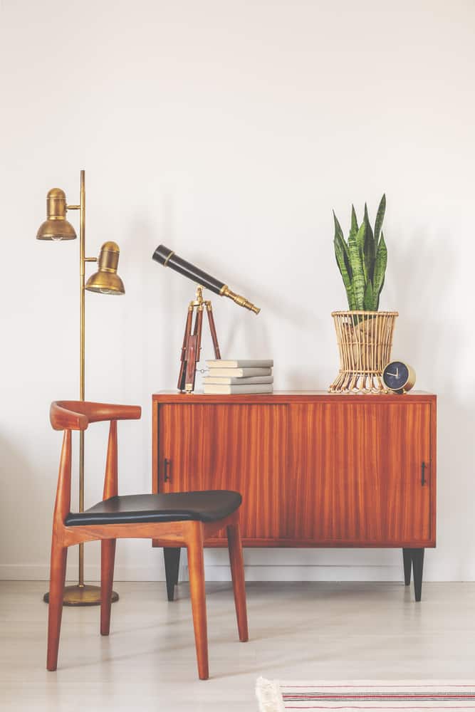 A mid-centry modern style chest, chair and table lamp.