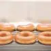 closeup of six Krispy Kreme original glazed donuts