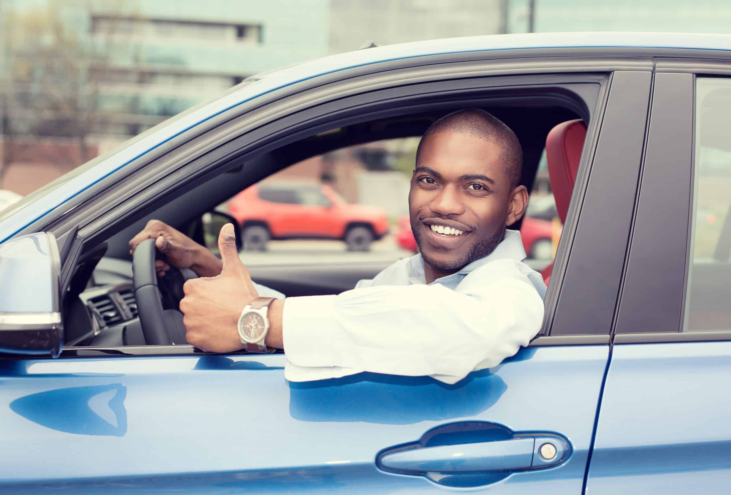 Save money on gas - Black man in blue car giving thumbs up