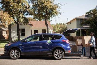 How to live without a car - Blue Zipcar and people carrying boxes