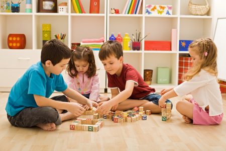 Children playing with blocks in a playroom.