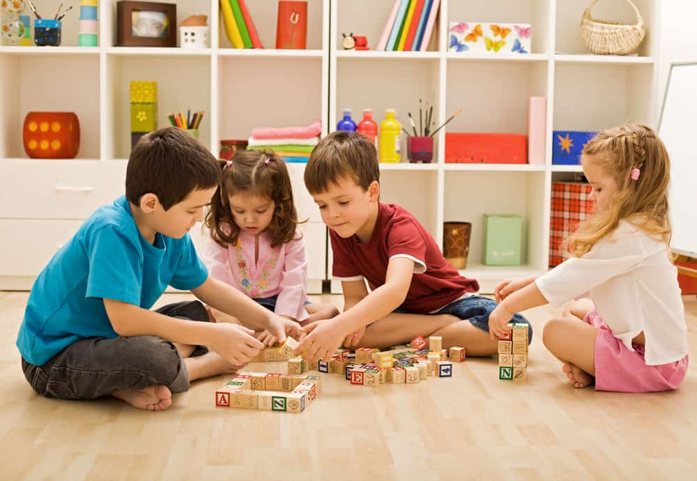 Children playing with blocks in a playroom.