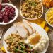 Thanksgiving dinner with all the traditional sides - turkey, mashed potatoes, gravy, green beans, stuffing, cranberries