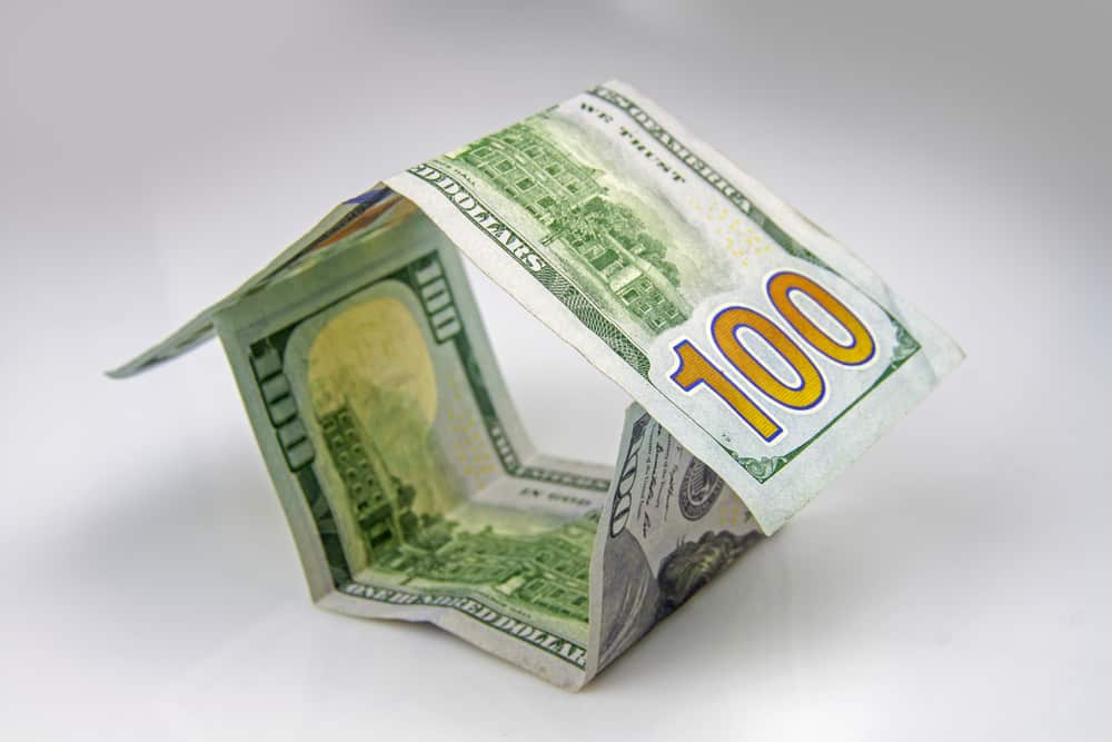 Illustration of house made by folding $100 dollar bills