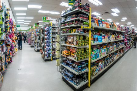 Wide angle view of merchandise in aisles of a dollar store.