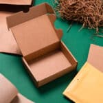 An empty box with shredded brown paper in the background.