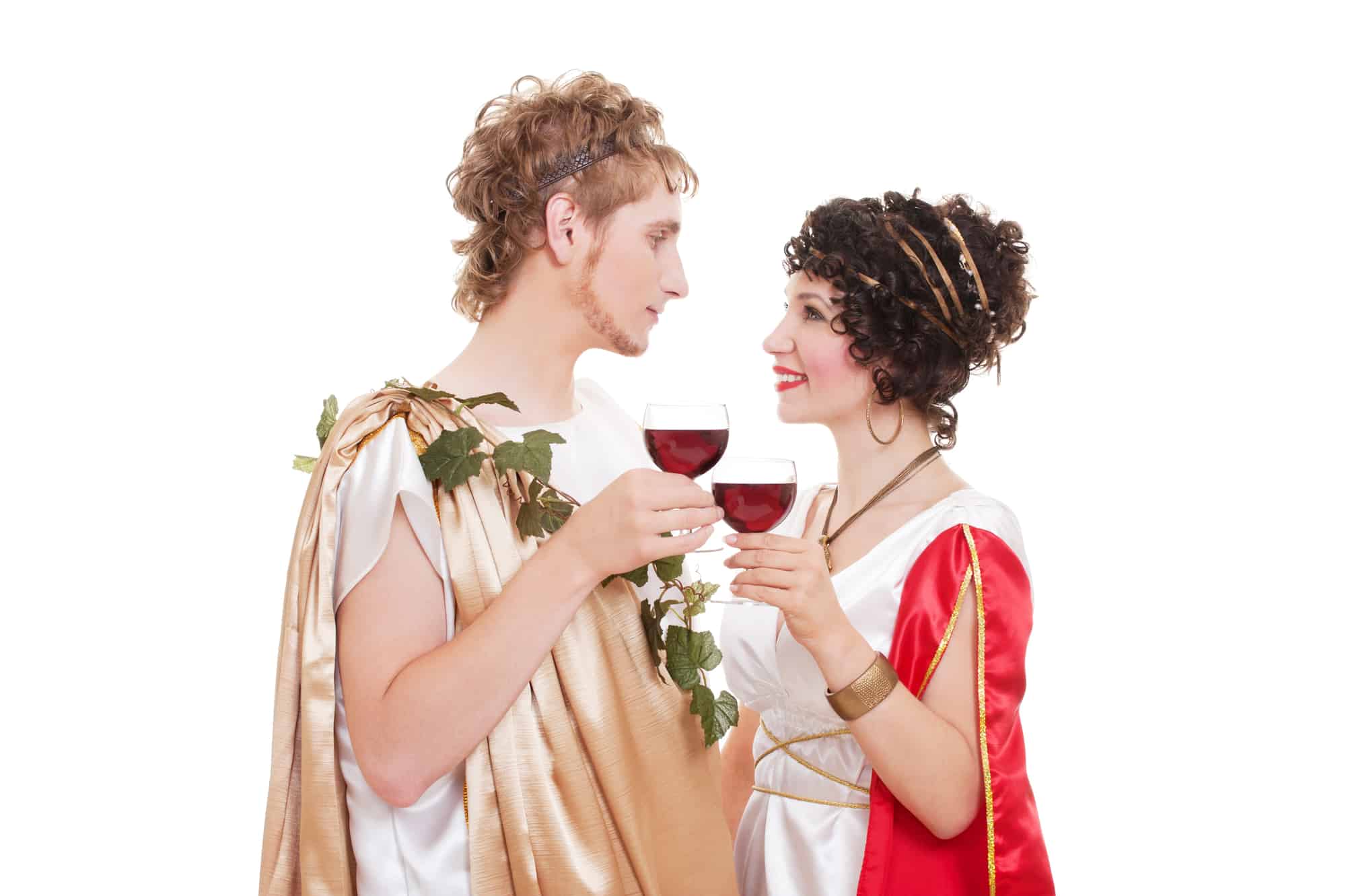 Man and woman in togas holding wine glasses and looking at each other.