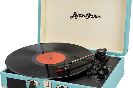 A retro portable record player in a turquoise case with a vinyl album on it