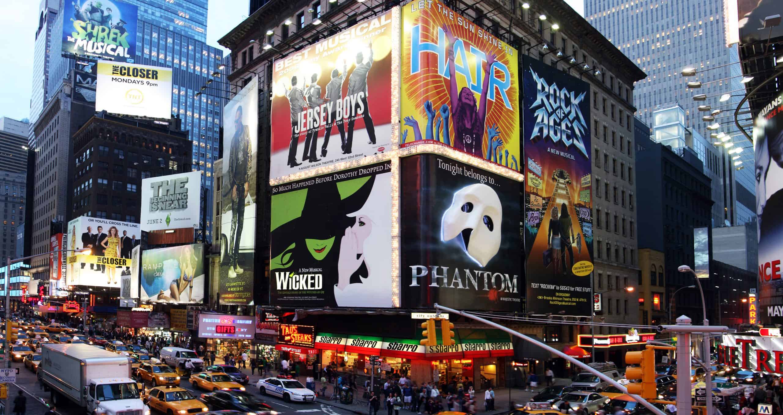 Times Square filled with billboards for Broadway shows.