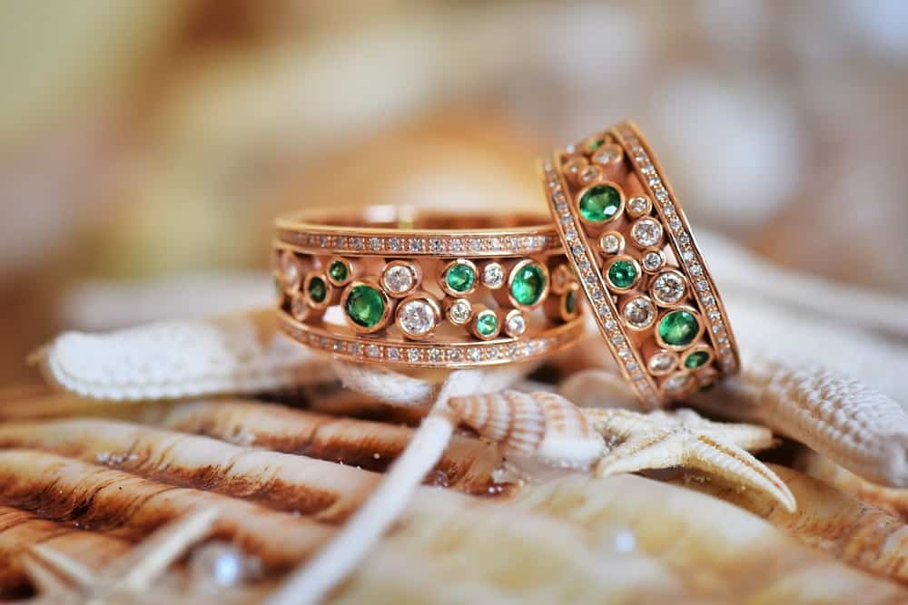 Two vintage diamond and emerald wedding rings