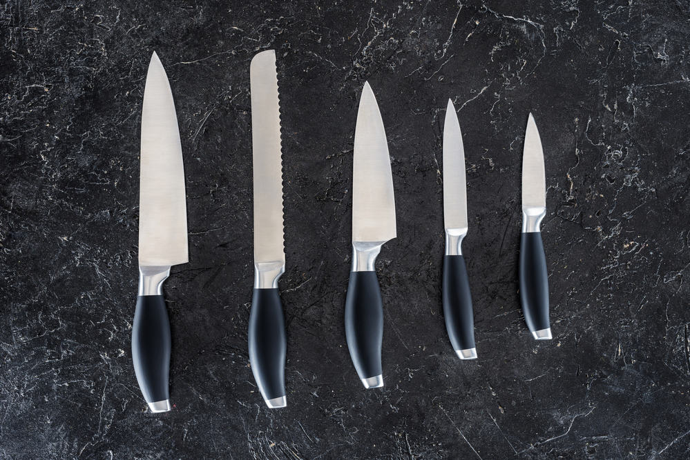 Kitchen knives on black marble counter