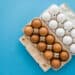 brown and white eggs in egg cartons